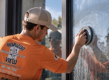 Horizon View technician using specialized mineral extraction pad to restore hard water etched glass